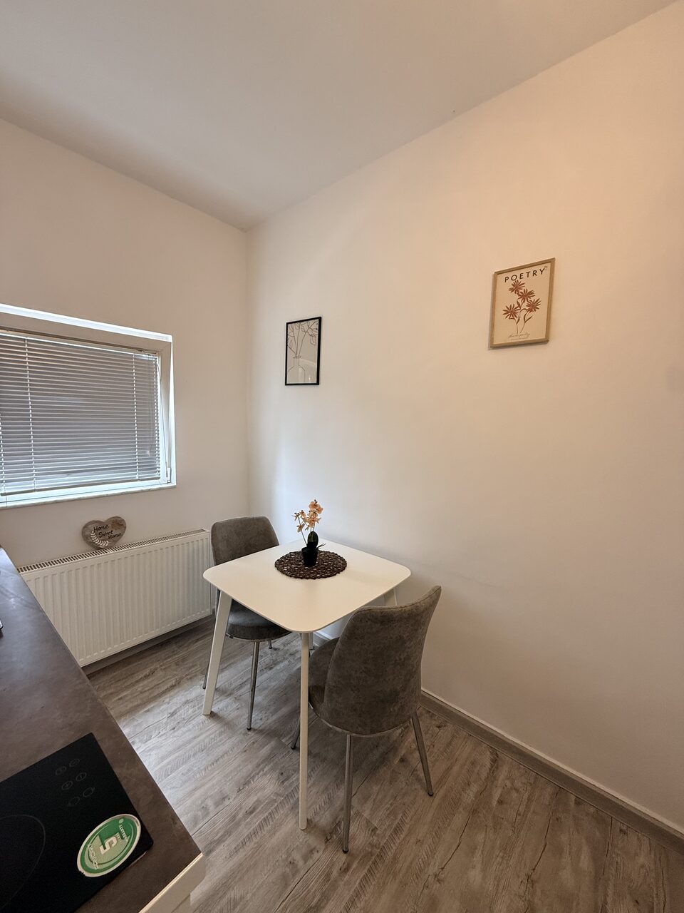 Cosy dining corner with a white table and two upholstered chairs